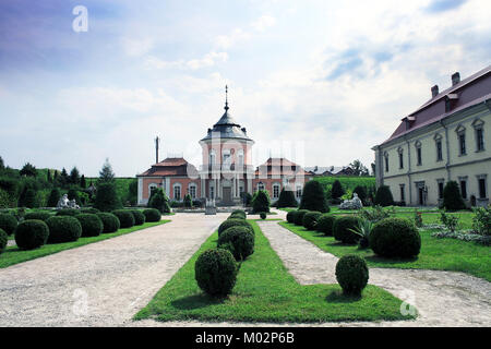 Ancient Zolochiv Castle against blue sky, garden and old sculptures in Lviv region, Ukraine Stock Photo