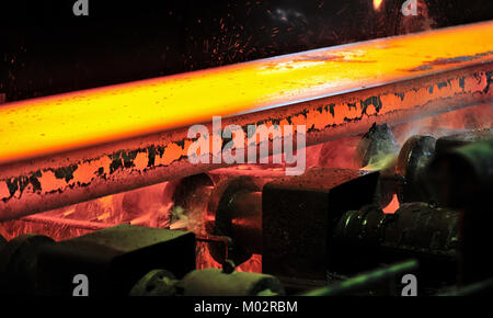 Red-hot steel slab on conveyor Stock Photo