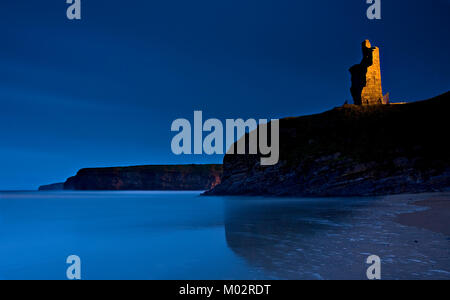 The ruins of Ballybunion castle at night on a headland on the west coast of Ireland Stock Photo