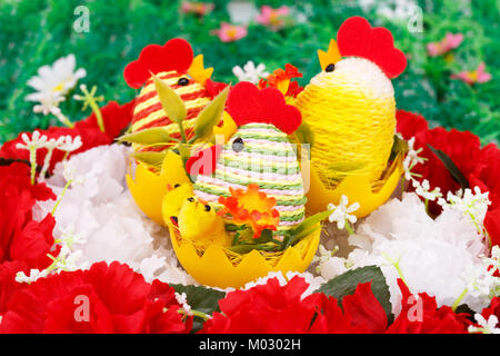 Easter setting with hens, chickens and eggs on flowers nest. Stock Photo