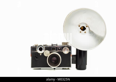 Old 35mm film camera wit flash on white background Stock Photo