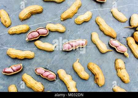 Opened peanuts pattern isolated on the rock background Stock Photo