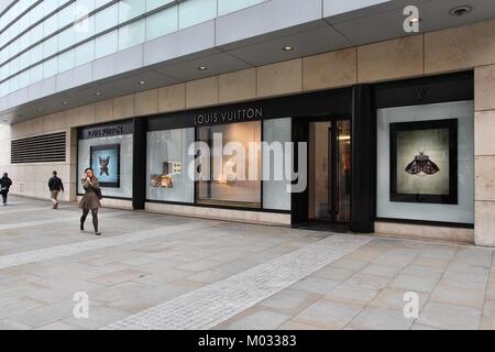 FILE--Shoppers walk past the fashion boutique of Louis Vuitton (LV) at the  Plaza 66 shopping mall in Shanghai, China, 1 September 2015. LVMH Moet H  Stock Photo - Alamy