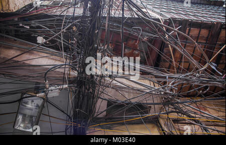 Messy electric wiring on the pole in Hanoi,Vietnam. Stock Photo