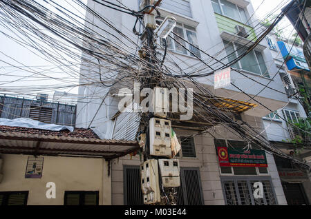 Hanoi,Vietnam - October 31,2017 : Messy electric wiring on the pole in Hanoi,Vietnam. Stock Photo