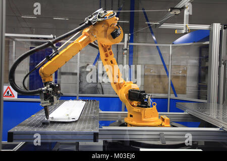 Industrial robotic arm in electronics production line Stock Photo