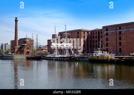 Liverpool dock with tall ship moored in harbour. The brig is Royalist, a training ship owned by the sea cadets. Stock Photo