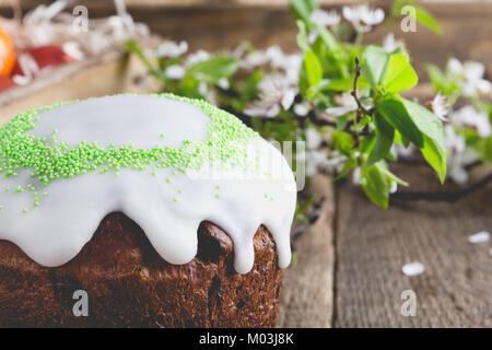 Easter cake, painted eggs and blooming plum twig, spring composition on wooden table Stock Photo