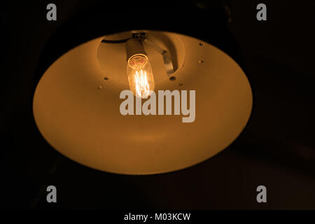 Light bulb illuminated and taken from above and isolated against black Stock Photo