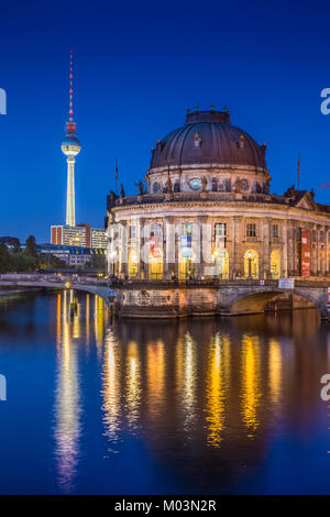 Beautiful view of famous Bode Museum at Museumsinsel (Museum Island) with TV tower and Spree river in twilight during blue hour at dusk, Berlin, Germa Stock Photo