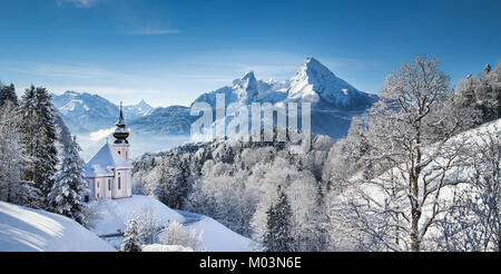 Panoramic view of beautiful winter landscape in the Bavarian Alps with pilgrimage church of Maria Gern and famous Watzmann massif in the background, N Stock Photo