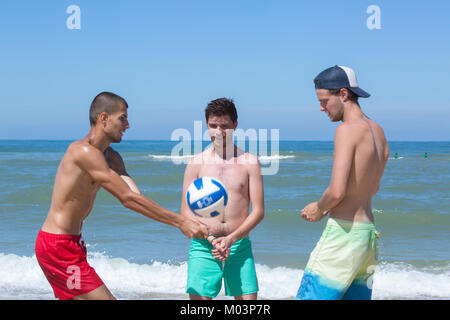 boys playing on the beach Stock Photo