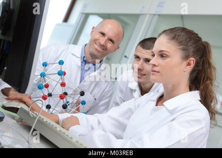 young scientists with dna model in laboratory Stock Photo