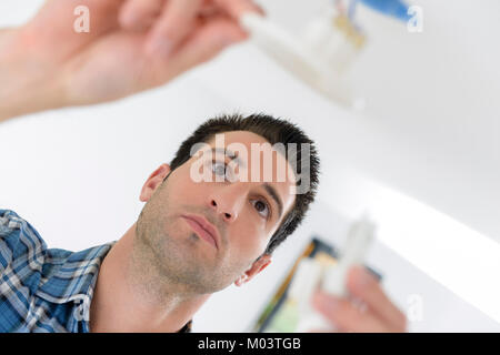 Plumber holding replacement part Stock Photo