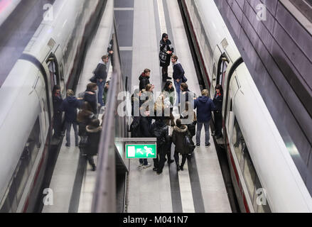 Berlin, Germany. 18th Jan, 2018. Passengers gather by an Intercity-Express train at the Berlin Central Train Station in Berlin, capital of Germany, on Jan. 18, 2018. All long-distance trains in Germany have been cancelled and at least three people were killed as a result of the storm 'Friederike', the German Press Agency (DPA) updated. Credit: Shan Yuqi/Xinhua/Alamy Live News Stock Photo