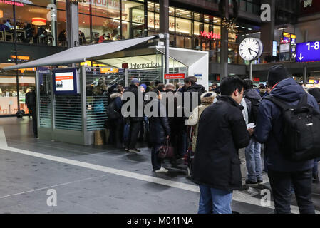 Berlin, Germany. 18th Jan, 2018. Passengers gather in front of an information counter at the Berlin Central Train Station in Berlin, capital of Germany, on Jan. 18, 2018. All long-distance trains in Germany have been cancelled and at least three people were killed as a result of the storm 'Friederike', the German Press Agency (DPA) updated. Credit: Shan Yuqi/Xinhua/Alamy Live News Stock Photo