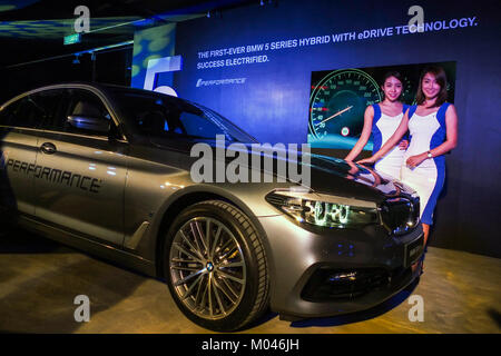 KUALA LUMPUR, MALAYSIA - JANUARY 18: A Model poses with BMW 530e Sport car inside the show room during introducing of the first BMW 5 Series Hybrid with Edrive in Kuala Lumpur on January 18, 2018. Credit: Samsul Said/AFLO/Alamy Live News Stock Photo