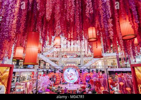 Kuala Lumpur, Malaysia. 19th Jan, 2018. People visit the decoration named 'Dream Garden of Prosperity' which is set to welcome the upcoming Chinese lunar New Year at Pavilion shopping mall in Kuala Lumpur, Malaysia, Jan. 19, 2018. Credit: Zhu Wei/Xinhua/Alamy Live News Stock Photo