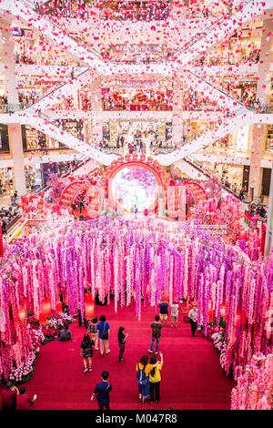 Kuala Lumpur, Malaysia. 19th Jan, 2018. People visit the decoration named 'Dream Garden of Prosperity' which is set to welcome the upcoming Chinese lunar New Year at Pavilion shopping mall in Kuala Lumpur, Malaysia, Jan. 19, 2018. Credit: Zhu Wei/Xinhua/Alamy Live News Stock Photo