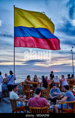 waving Colombian flag again sunset sky at Cafe del Mar, Cartagena de Indias Stock Photo