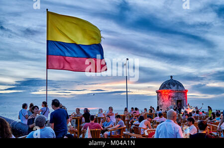 waving Colombian flag again sunset sky at Cafe del Mar, Cartagena de Indias Stock Photo