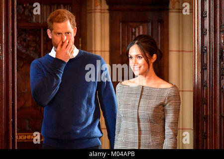 Prince Harry and Meghan Markle arrive in the banqueting hall during a visit to Cardiff Castle. Stock Photo