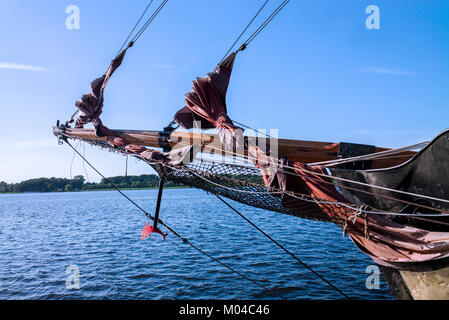 Anchor and bow sails on wooden sailing boat Stock Photo