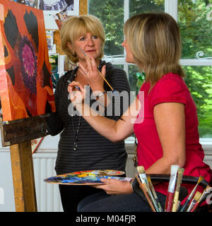 A small group of people in an artists studio for art class tuition Stock Photo