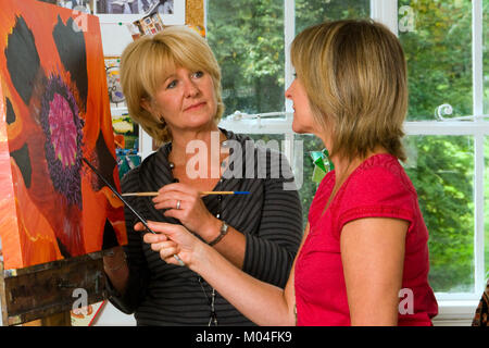 A small group of people in an artists studio for art class tuition Stock Photo