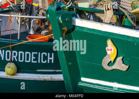 The fishing port of Greetsiel, East Frisia, Ostfriesland, Lower Saxony, Germany, Shrimp trawler, shrimpcutter, in the harbor, light ice cover on the w Stock Photo