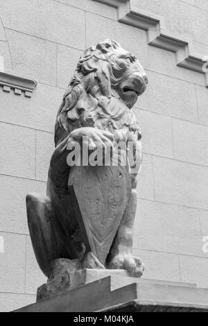 Sculpture of a lion with the arms Stock Photo