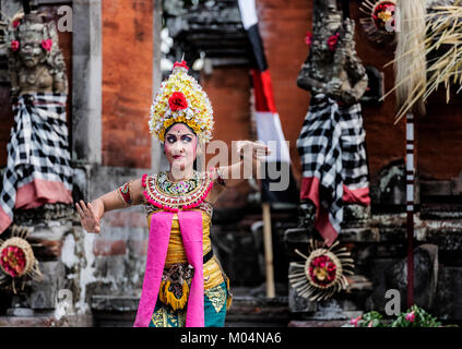 Bali, Indonesia - October 2015: women wearing traditional costume performing Barong Dance at stage in a small temple in Bali, Indonesia Stock Photo