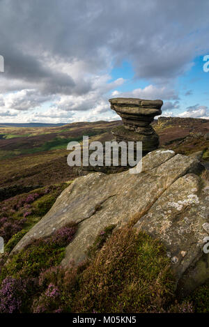 The Salt Cellar on Derwent Edge in the Peak District national park. A gritstone rock formation surrounded by Heather. Stock Photo