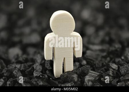 Single male stands alone in front of black Stock Photo