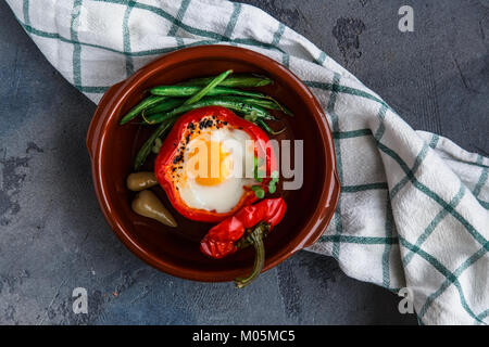 baked bell peper halves stuffed with eggs and sausage, top view. Stock Photo