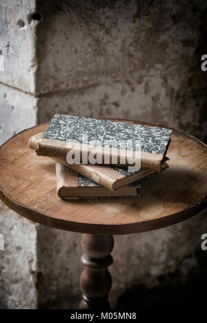 Old books on an old wooden table. Stock Photo