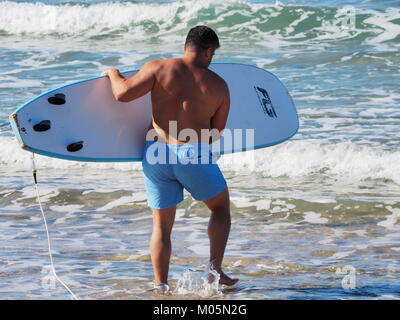 wave surfers at the sea on a perfect clear day Stock Photo