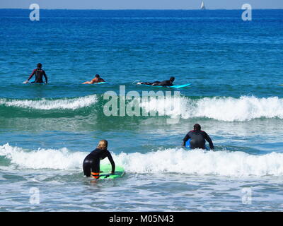 wave surfers at the sea on a perfect clear day Stock Photo