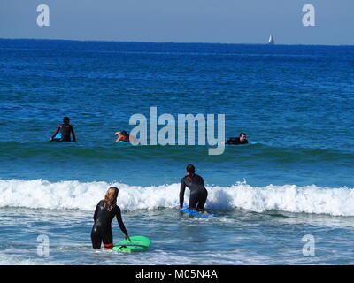 wave surfers at the sea on a perfect clear day Stock Photo
