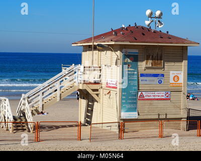 closed lifeguard station with public notice signs that bathing is prohibited at the beach during summer time in Tel Aviv Stock Photo