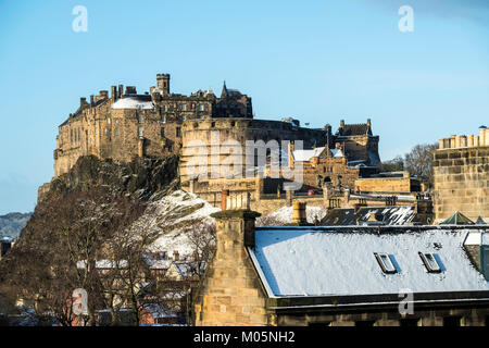 View of Edinburgh Castle across snow covered roofs of houses , Scotland, United Kingdom Stock Photo