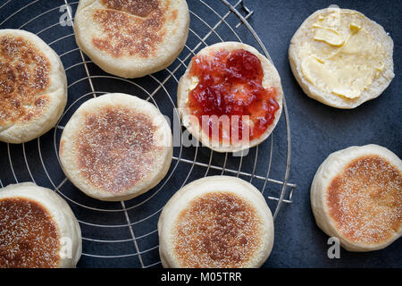 English Muffins with strawberry jam on a slate background Stock Photo