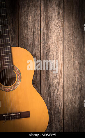 Old classic guitar on a wooden background Stock Photo