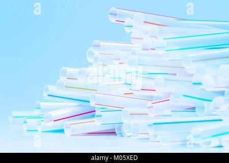 Bunch of drinking straws isolated on a blue background. Stock Photo