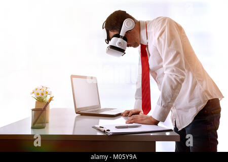 Businessman watching images of virtual reality on the table. Horizontal composition. Stock Photo