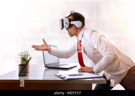 Very surprised businessman using virtual reality glasses resting on his office desk. Horizontal composition. Stock Photo