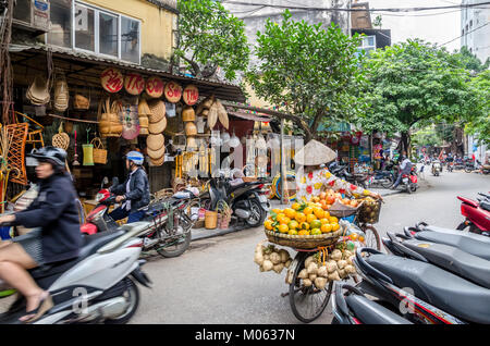 Hanoi,Vietnam - November 5,2017 : Local daily life of the street in Hanoi, Vietnam. Street vendors selling various types of vegetables from bicycle. Stock Photo