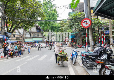 Hanoi,Vietnam - November 5,2017 : Local daily life of the street in Hanoi, Vietnam. Street vendors selling various types of vegetables from bicycle. Stock Photo