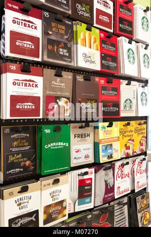 Restaurant, food, and drink gift cards for sale on a store display rack. Stock Photo