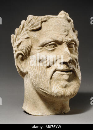 Limestone head of bearded male votary with wreath of leaves MET GR337 74.51.2811 Stock Photo